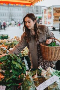 Woman at farmer's market gathering fresh produce
